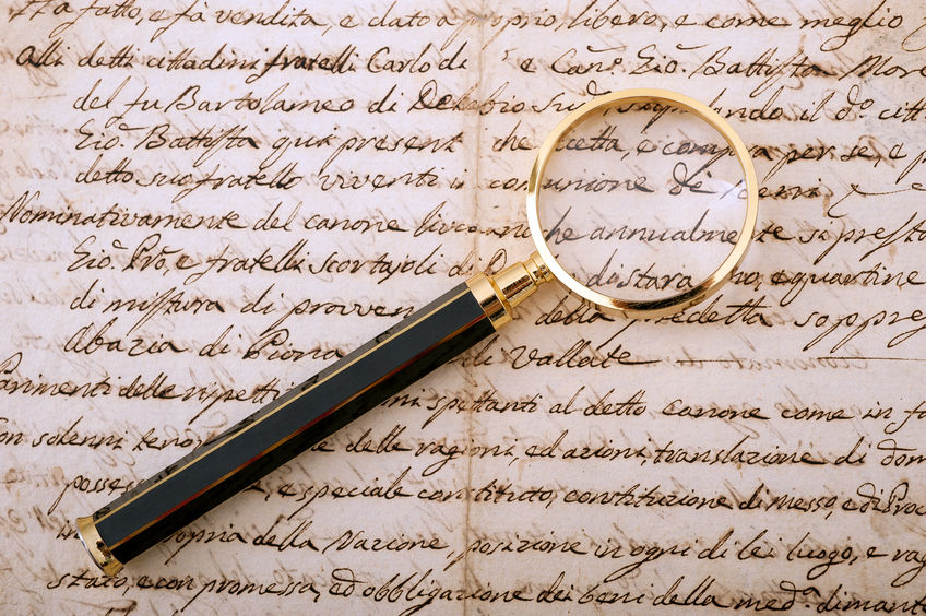 29043308 - magnifying glass on an old handwritten letter